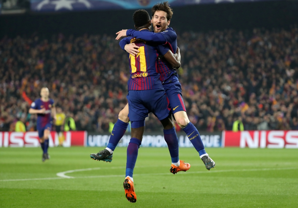 Barcelona's Ousmane Dembele celebrates with Lionel Messi after scoring their second goal. REUTERS
