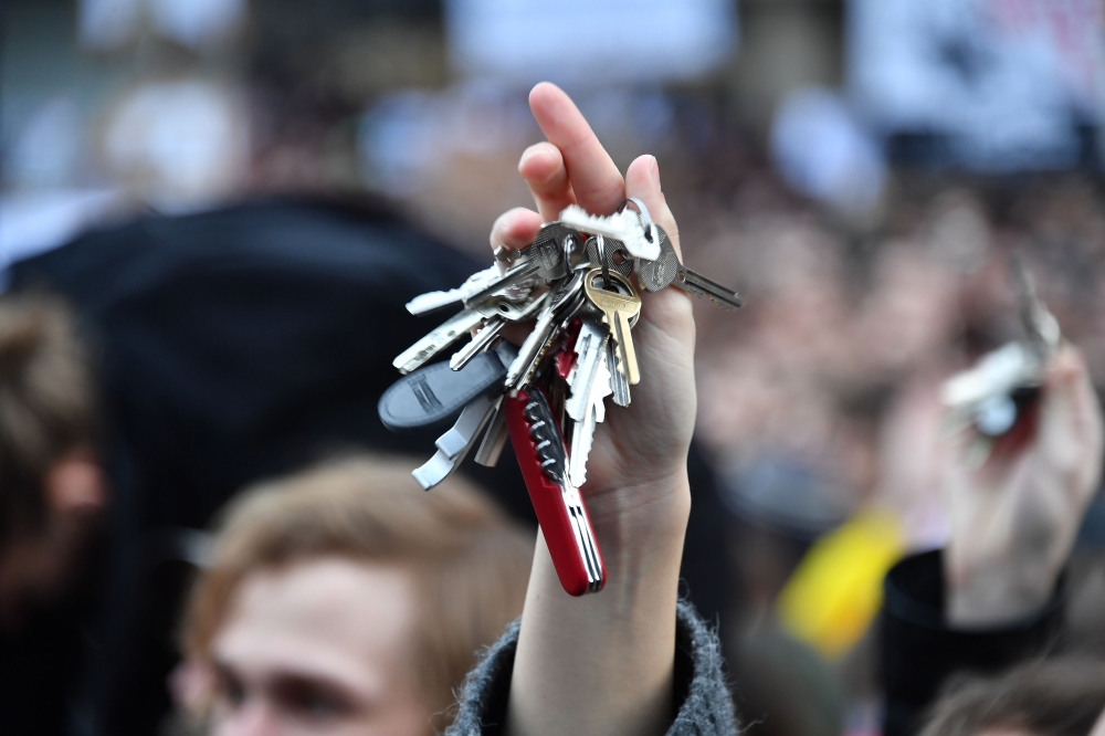 A protester holds up keys near the Slovak National Uprising (SNP) square during a rally under the slogan 