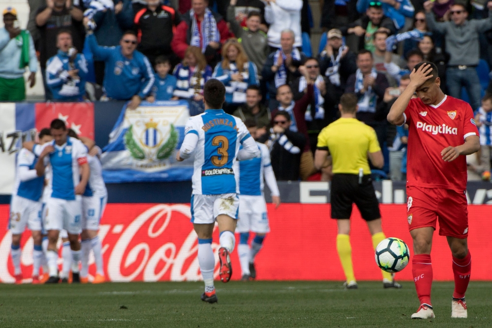 Sevilla's French forward Wissam Ben Yedder (R) reacts after Leganes' players scored their second goal during the Spanish League football match between Club Deportivo Leganes SAD and Sevilla FC at the Estadio Municipal Butarque in Leganes on March 18, 2018