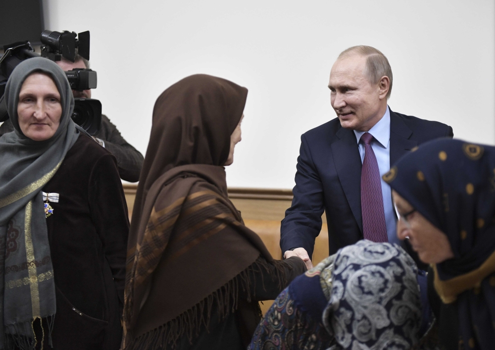 Russian President Vladimir Putin (R, back) attends a meeting with local residents in Makhachkala, Russia March 13, 2018. Sputnik/Alexei Nikolsky/Kremlin via Reuters