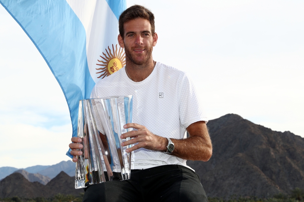 Juan Martin Del Potro of Argentina poses with the winner's trophy after defeating Roger Federer of Switzerland during the men's final on Day 14 of the BNP Paribas Open at the Indian Wells Tennis Garden on March 18, 2018 in Indian Wells, California. Matthe