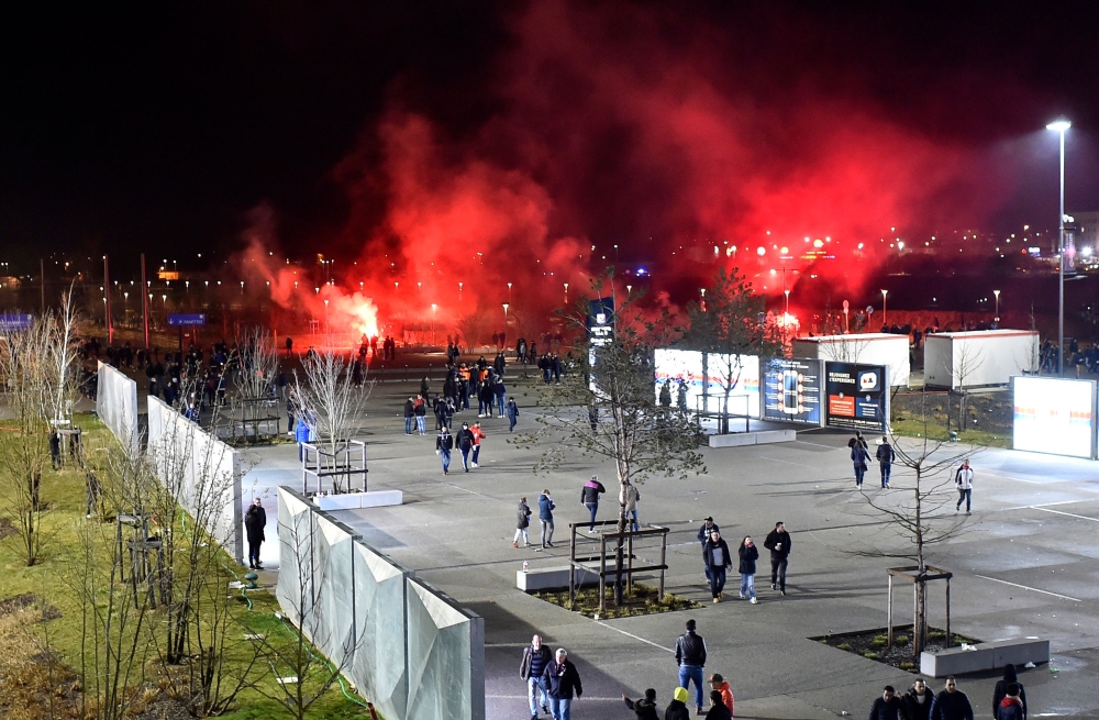 Lyon's fans use red flares before the Europa League football match Olympique Lyonnais (OM) vs CSKA Moscow on March 15, 2018, at the Groupama Stadium in Decines-Charpieu, central-eastern France. / AFP / ROMAIN LAFABREGUE
