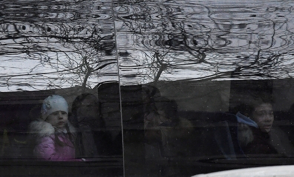 Children sit on a bus with diplomatic number plates as embassy staff and children arrive at Russia's Embassy in London, Britain, March 20, 2018. REUTERS/Toby Melville