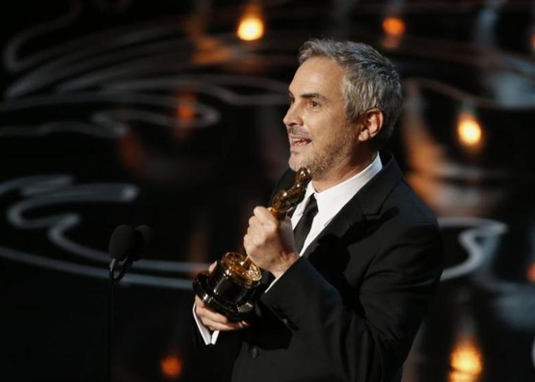 Alfonso Cuaron accepts the Oscar for best director for 