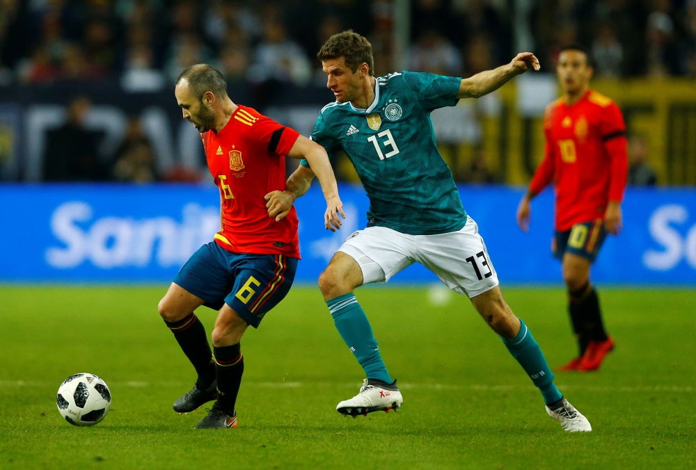 Spain’s Andres Iniesta in action with Germany’s Thomas Mueller REUTERS/Thilo Schmuelgen
