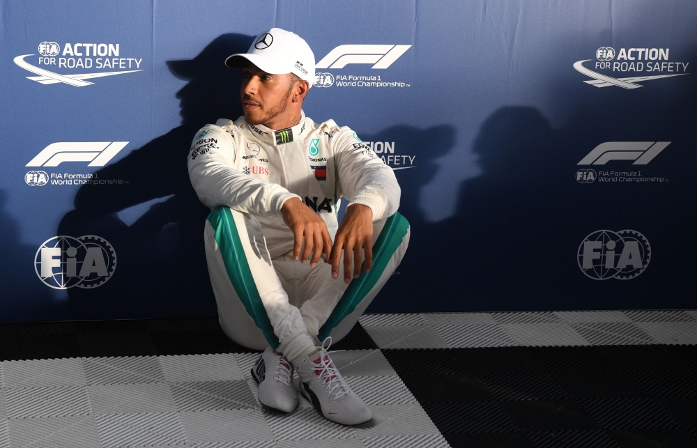 Mercedes' British driver Lewis Hamilton reacts after taking pole position after the Formula One qualifying session in Melbourne on March 24, 2018, ahead of the Formula One Australian Grand Prix