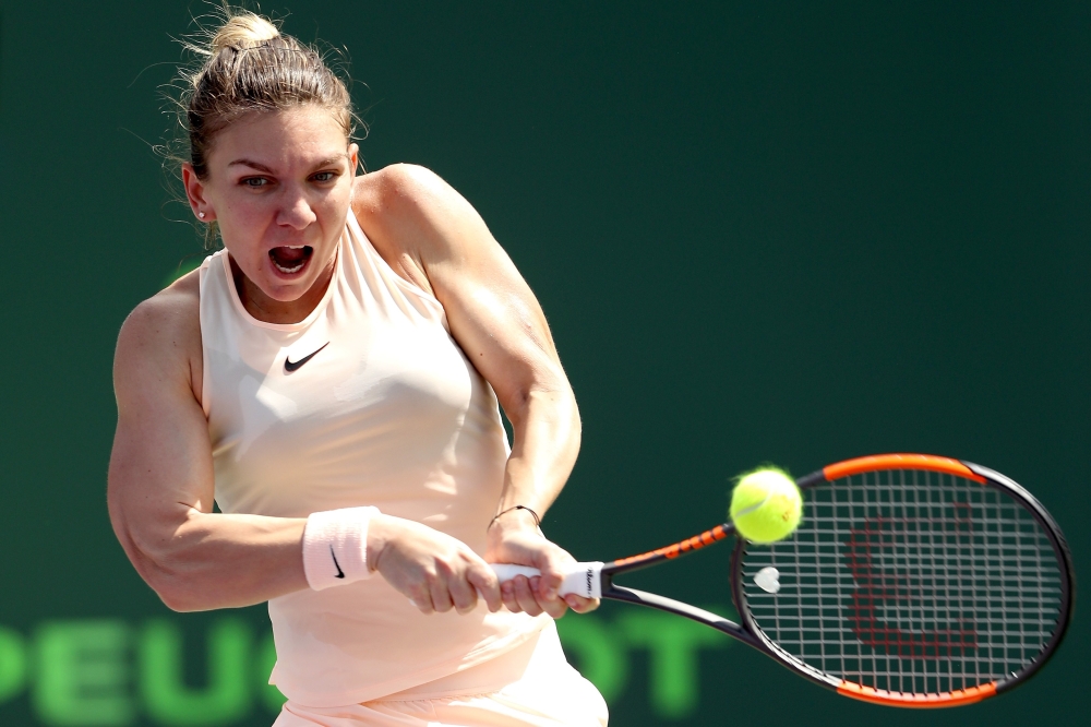  Simona Halep of Romania returns a shot to Agnieszka Radwanska of Poland during the Miami Open Presented by Itau at Crandon Park Tennis Center on March 24, 2018 in Key Biscayne, Florida. Matthew Stockman/Getty Images/AFP