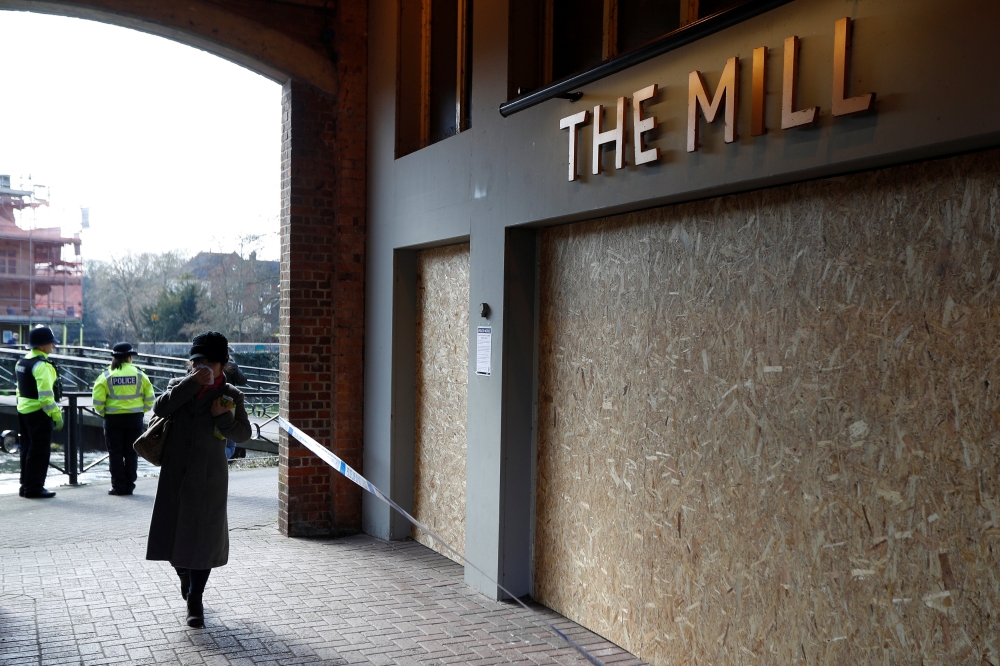 Police officers stand by the Mill pub as inspectors from the Organisation for the Prohibition of Chemical Weapons (OPCW) arrive to begin work at the scene of the nerve agent attack on former Russian agent Sergei Skripal, in Salisbury, Britain March 21, 20