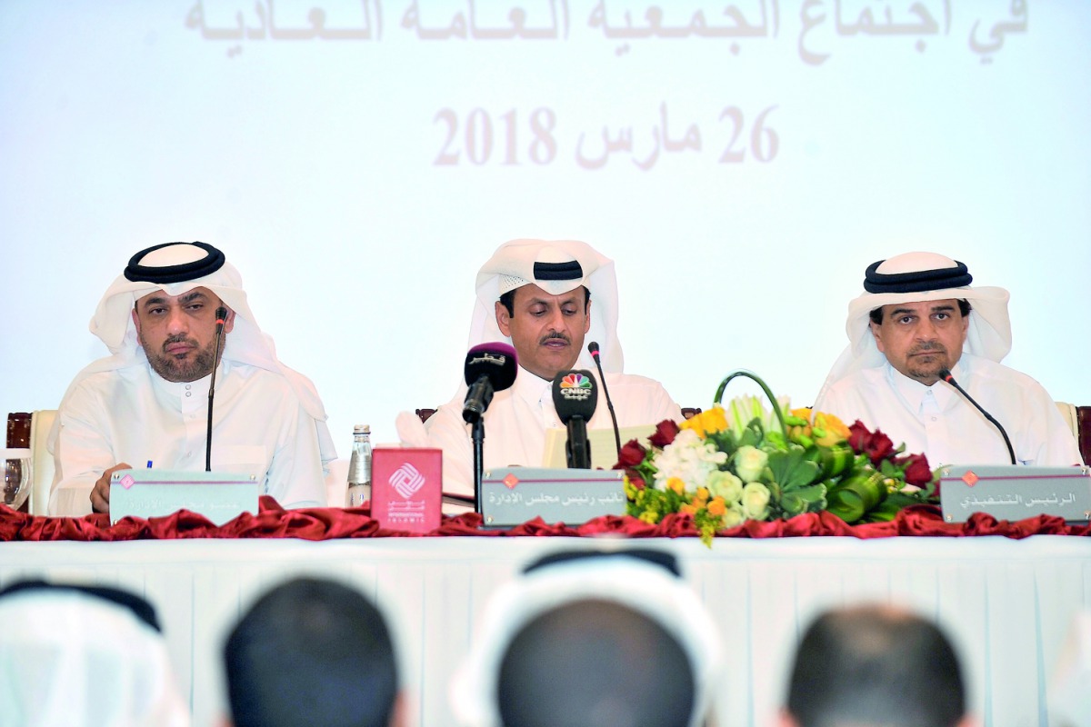 Sheikh Abdullah bin Thani bin Abdullah Al Thani (centre), Vice-Chairman  of QIIB;  Dr Abdulbasit Ahmad Al Shaibei (right), CEO; and a Board Member at the Ordinary General Assembly Meeting of the bank, yesterday.  Pic: Baher Amin/ The Peninsula
