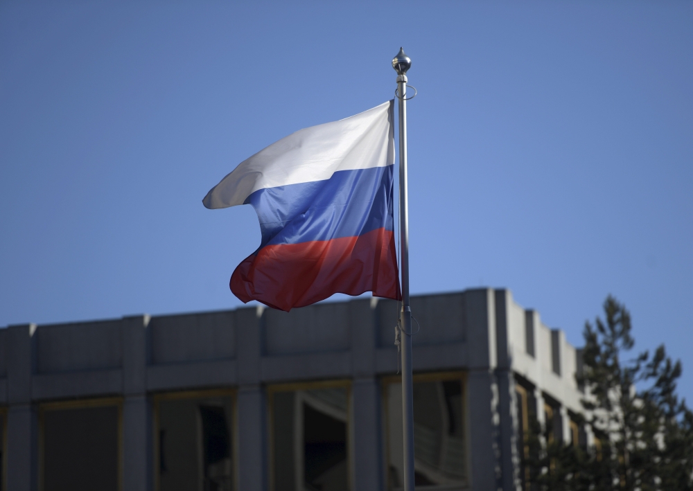 The Russian flag flies on the pole of the Embassy of Russia in Helsinki, Finland on March 27, 2018.  AFP / Lehtikuva / Vesa Moilanen
