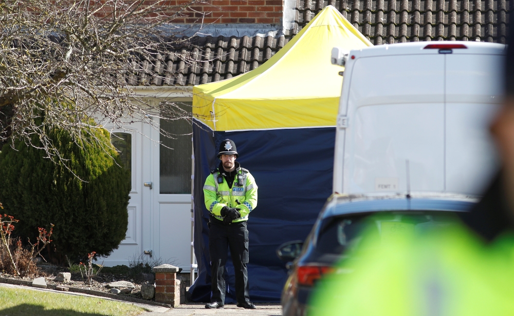 A police officer stands guard outside of the home of former Russian military intelligence officer Sergei Skripal, in Salisbury, Britain, March 8, 2018. REUTERS/Peter Nicholls