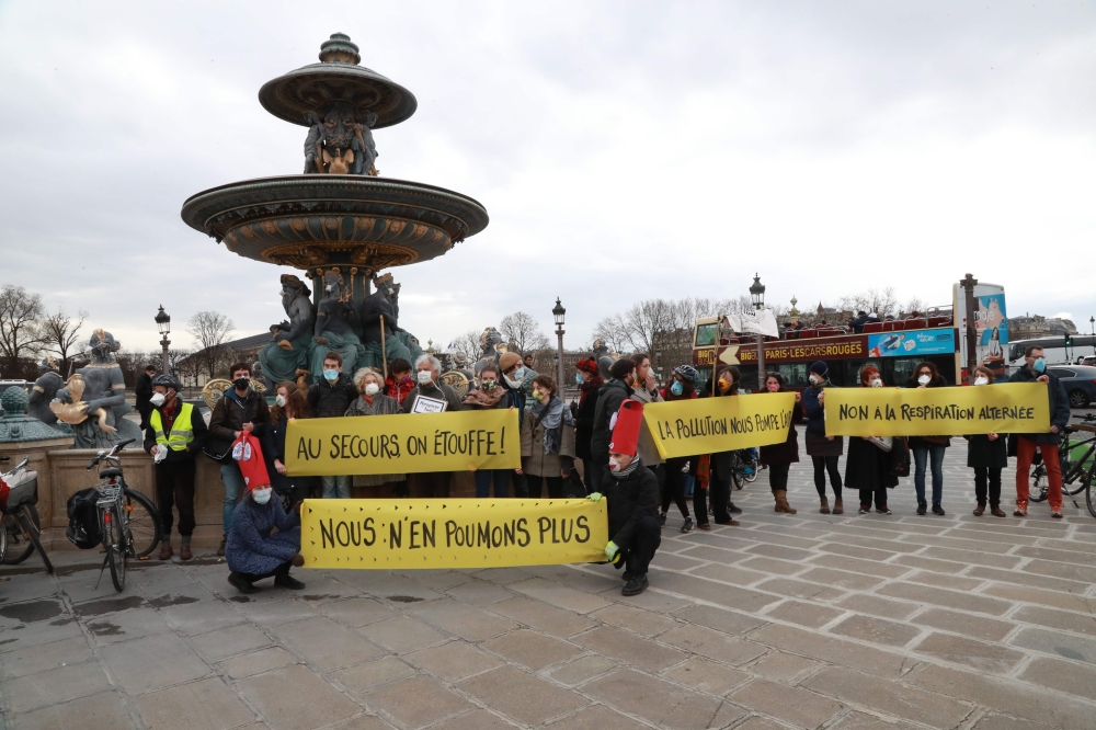 Demonstrators hold banners reading 