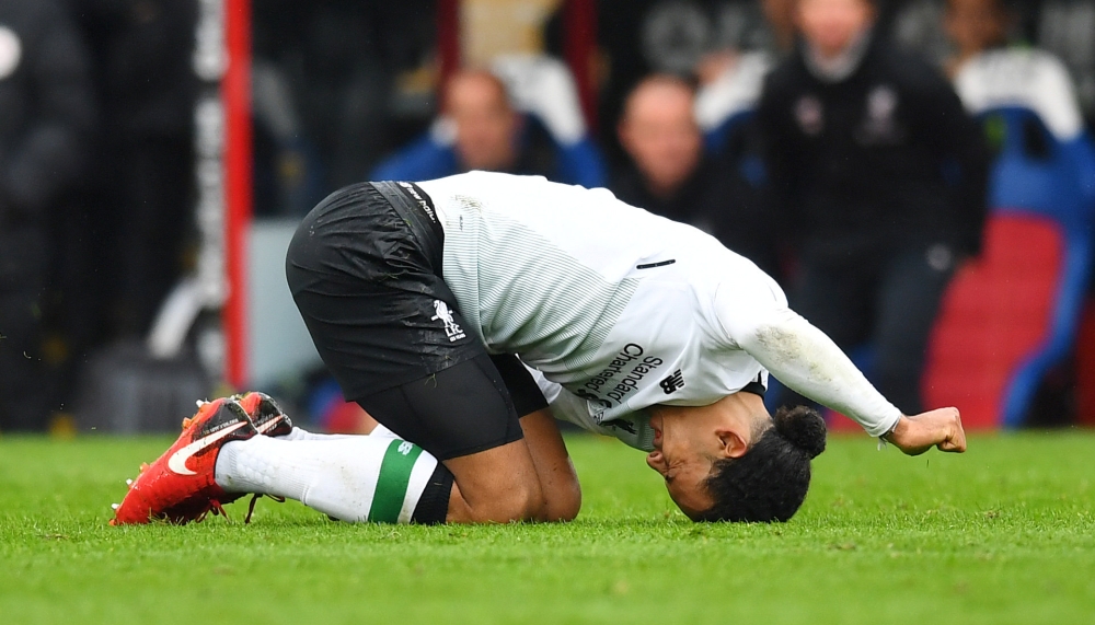 Liverpool's Virgil van Dijk reacts after sustaining an injury REUTERS/Dylan Martinez  
