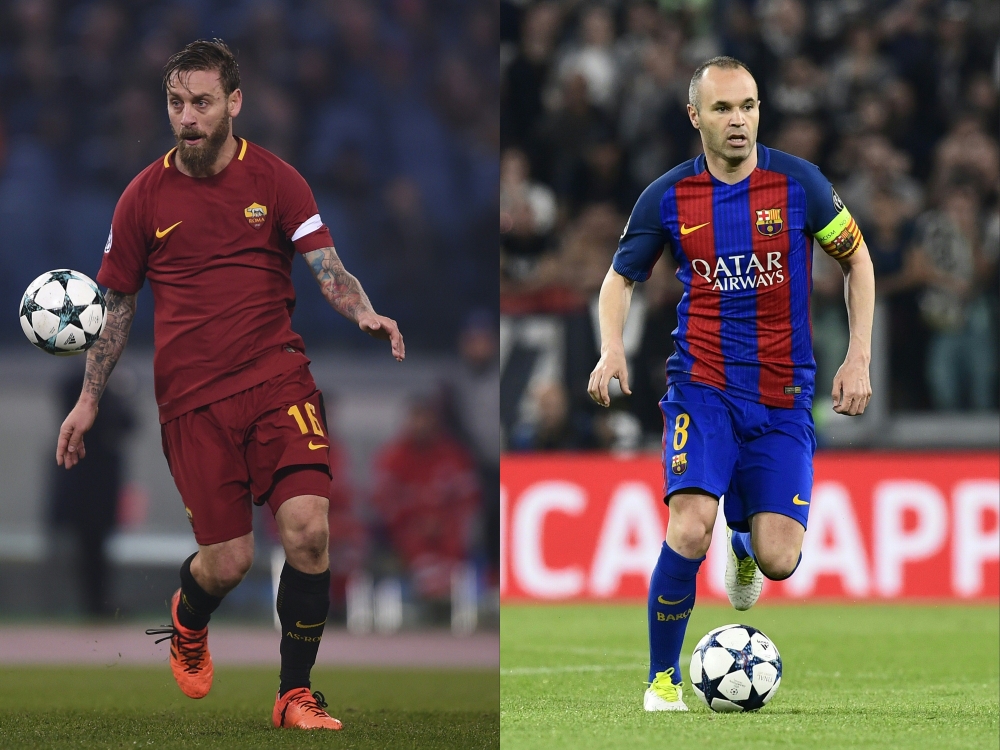 (COMBO) Roma's Italian midfielder Daniele De Rossi (L) and Barcelona's midfielder Andres Iniesta . AFP / Filippo MONTEFORTE AND MIGUEL MEDINA

