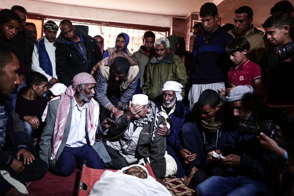 Palestinians mourn around the body of Shadi al-Kashif, who was murdered by the Israeli army during 