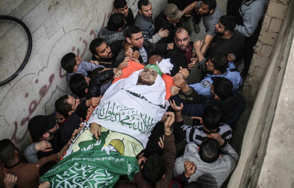 Palestinians carry the body of 23-year-old Palestinian Nabil al- Hadri who has been killed in Israeli airstrike during a funeral ceremony in Gaza City, Gaza on April 5, 2018. (Ali Jadallah / Anadolu Agency)