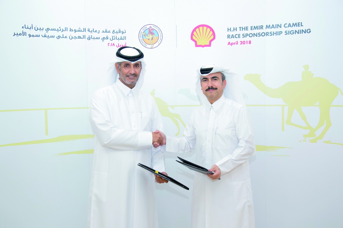 Officials exchanging documents after signing the Shell’s three-year sponsorship agreement of Emir’s main camel race.