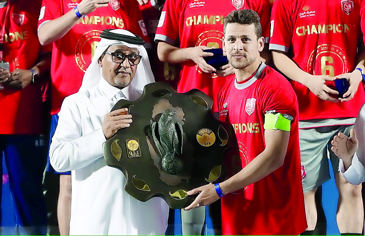 Al Duhail skipper Youssef Msakni receiving the Falcon Shield from Qatar Football Association Vice-President Saoud Al Mohannadi on Saturday. Pictures: Baher Amin / The Peninsula