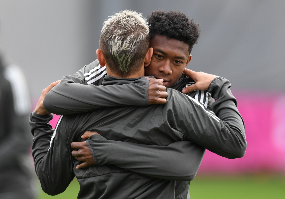 Bayern Munich's Brazilian defender Rafinha (L) and Bayern Munich's Austrian defender David Alaba joke during a training session at the trainings ground of FC Bayern Munich in Munich, southern Germany, on April 10, 2018 on the eve of the UEFA Champions Lea