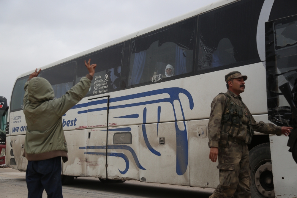 A Syrian kid gestures with victory sign as 17th convoy of vehicles, carrying civilians from Syria’s Eastern Ghouta district, arrive in Al-Bab district, in Aleppo in Syria on April 10, 2018. Beha el Halebi - Anadolu
