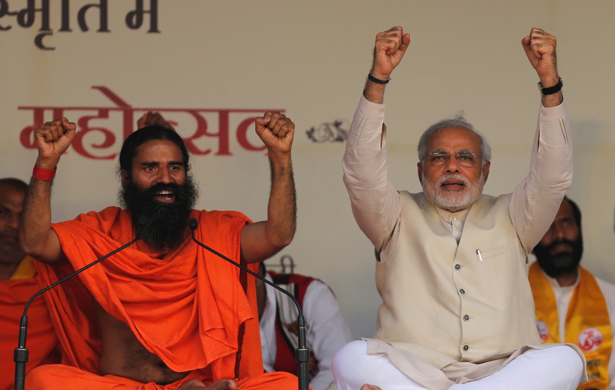 Narendra Modi and Indian yoga guru Baba Ramdev raise their hands as they chant patriotic slogans during a Yoga Mahotsav in New Delhi, March 23, 2014. (Reuters / Adnan Abidi) 