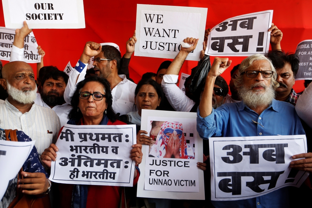 People shout slogans and hold placards during a protest against the rape of an eight-year-old girl, in Kathua, near Jammu and a teenager in Unnao, Uttar Pradesh state, in Mumbai, India April 13, 2018. REUTERS/Francis Mascarenhas