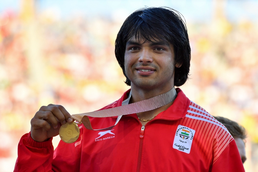 India’s Neeraj Chopra (gold) poses with his medal after the athletics men's javelin throw final during the 2018 Gold Coast Commonwealth Games at the Carrara Stadium on the Gold Coast on April 14, 2018. AFP / Saeed Khan 