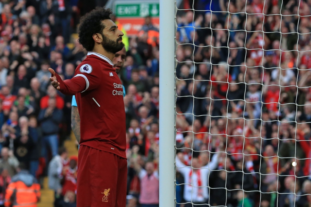 Liverpool's Egyptian midfielder Mohamed Salah celebrates after scoring their second goal during the English Premier League football match between Liverpool and Bournemouth at Anfield in Liverpool, north west England on April 14, 2018.  AFP / Lindsey PARNA