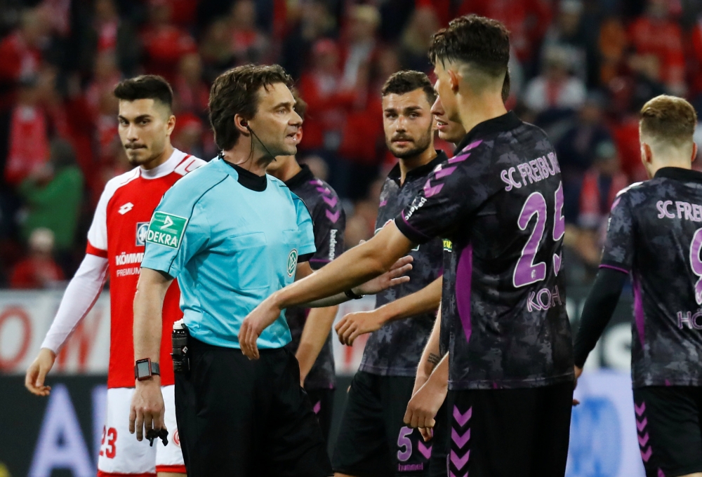 SC Freiburg's Robin Koch speaks with referee Guido Winkmann after a penalty is awarded to Mainz REUTERS/Kai Pfaffenbach 
