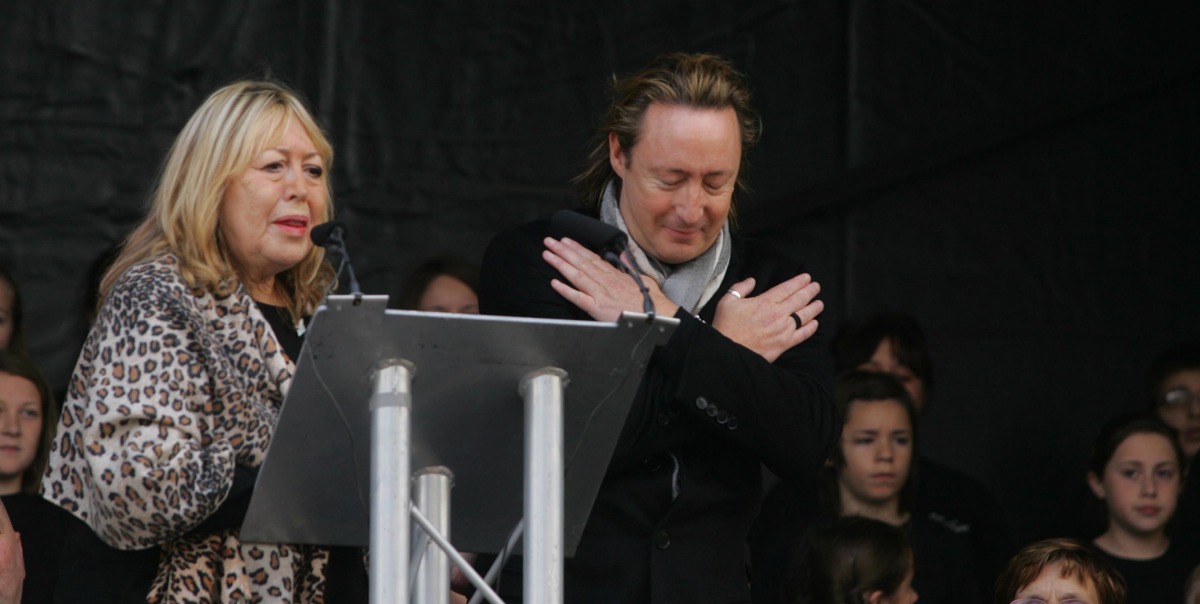 Cynthia and Julian Lennon at the unveiling of the John Lennon Peace Monument in Chavasse Park, Liverpool on 9th October 2010 with the Liverpool Signing Choir in the background. Celebrating peace and the loving memory of John Lennon on what would have been