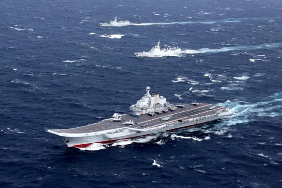 File photo of China's aircraft carrier with accompanying fleet conducts a drill in the South China Sea. Reuters
