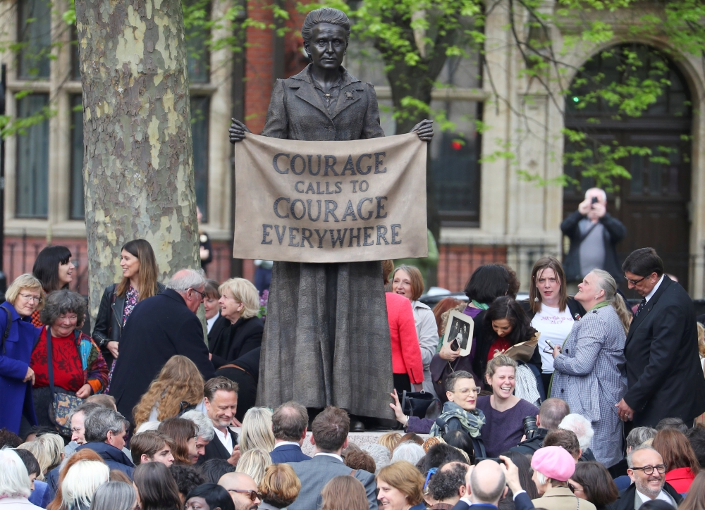 People attending the official unveiling gather around the statue of suffragist Millicent Fawcett on Parliament Square after the ceremony, in London, Britain, April 24, 2018. REUTERS/Hannah McKay