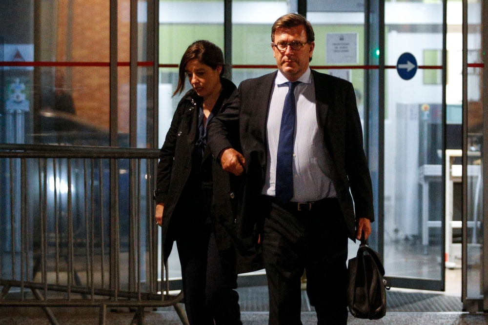 Vincent Bollore's lawyers Olivier Baratelli (R) and Celine Astolfe (L) leave overnight on April 24, 2018, the anti-corruption police office (OCLCIFF) in Nanterre, western suburbs of Paris, after the detention of Billionaire French tycoon Vincent Bollore a
