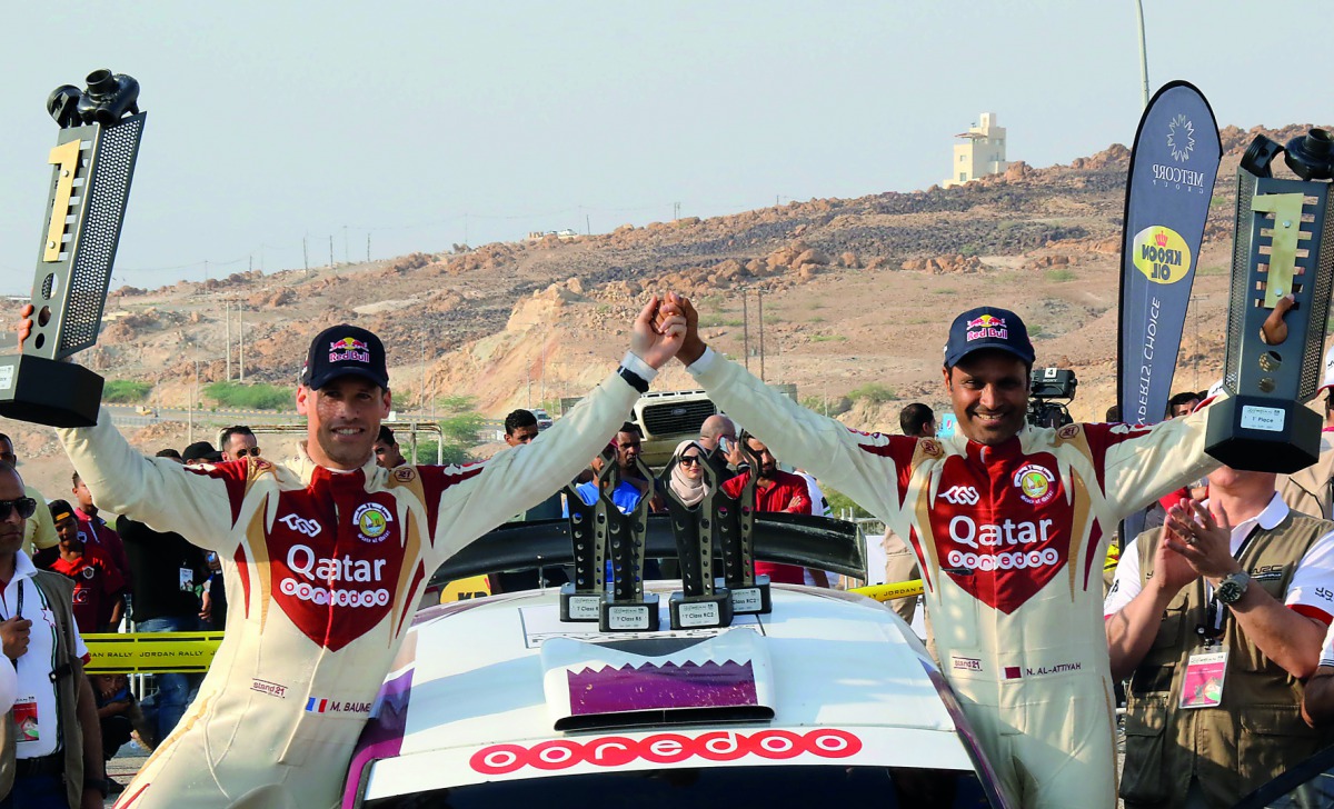 Qatar’s Nasser Saleh Al Attiyah and his French navigator Matthieu Baumel celebrate on the podium after winning the Jordan Rally at Dead Sea, Jordan yesterday.