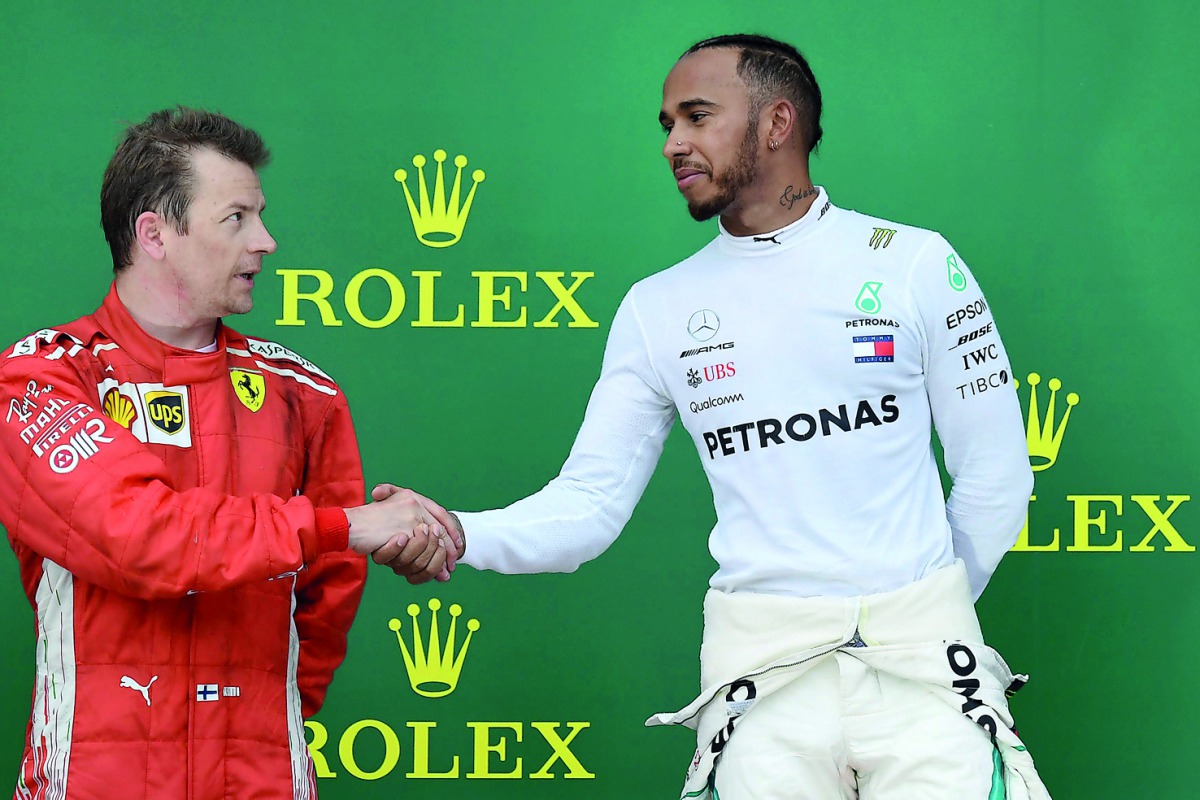 Race winner Mercedes’ British driver Lewis Hamilton (right) shakes hands with second-placed Ferrari’s Finnish driver Kimi Raikkonen as they celebrate on the podium of the Azerbaijan Grand Prix at the Baku City Circuit in Baku  yesterday. 