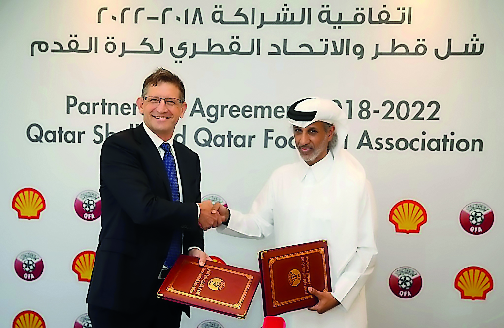Sheikh Hamad bin Khalifa bin Ahmed Al Thani, the QFA President, and Andrew Faulkner, the Managing Director and Chairman of Qatar Shell Companies, shake hands during a sponsorship signing ceremony in Doha. 