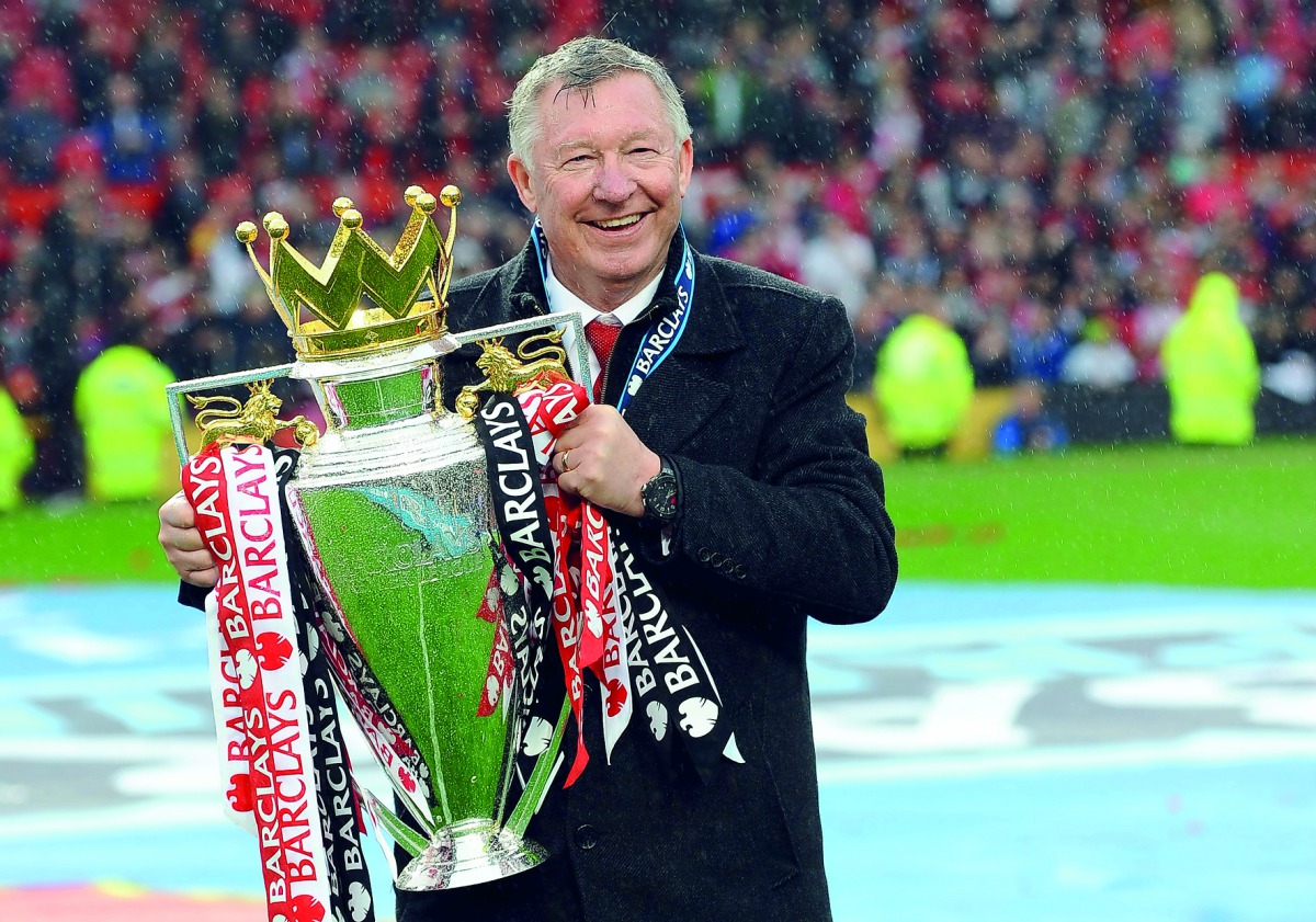 n this file photo taken on May 12, 2013 Manchester United's Scottish manager Alex Ferguson holds the Premier League trophy at the end of the English Premier League football match between Manchester United and Swansea City at Old Trafford in Manchester, no