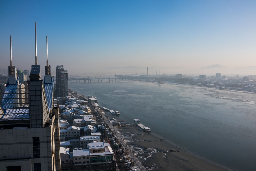 This January 9, 2018 photo shows the North Korean town of Sinuiju (R) opposite Dandong (L) in China's northeast Liaoning province. The dramatic diplomatic thaw on the Korean peninsula is sparking an unexpected economic windfall on the Chinese border, wher