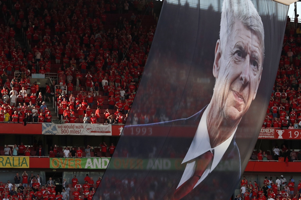 A large photograph of Arsenal's French manager Arsene Wenger is suspended from the roof as players take a lap of honour on the pitch after the English Premier League football match between Arsenal and Burnley at the Emirates Stadium in London on May 6, 20