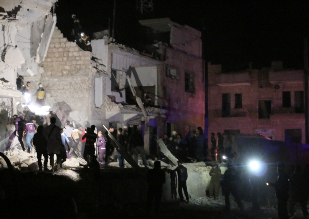 Civil defence crews and locals conduct search and rescue works after a bomb laden car explodes in front of the district hospital near the court house in Idlib, Syria on May 12, 2018. At least 12 people died and 25 injured. Khalaf Joumaa - Anadolu 
