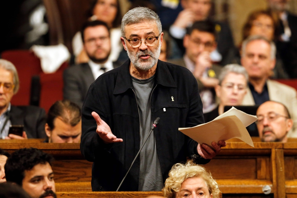 'Candidatura d'Unitat Popular' - CUP's (Popular Unity Candidacy) member of Catalan parliament Carles Riera gestures as he speaks at the session at the Catalan parliament in Barcelona on May 12, 2018. AFP / Pau Barrena