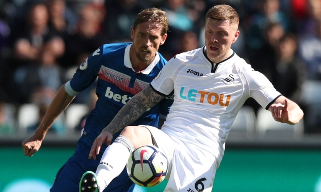 Swansea City's Alfie Mawson with Stoke City's Peter Crouch.  via Reuters/Peter Cziborra