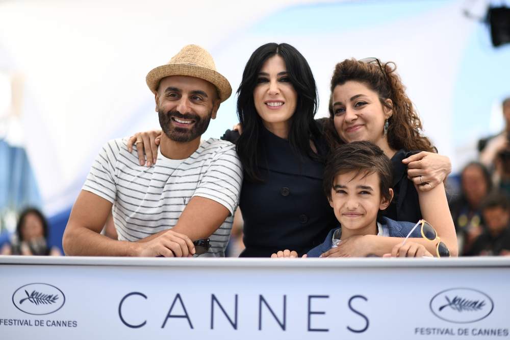 (FromL) Screenwriter Jihad Hojeily, Lebanese director and actress Nadine Labaki, screenwriter Marianne Katra and Syrian actor Zain al-Rafeea pose on May 18, 2018 during a photocall for the film 