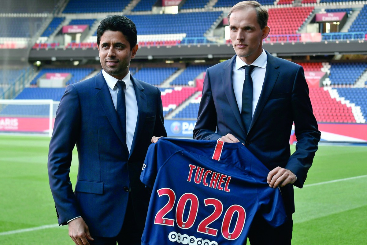 French Ligue 1 football club Paris Saint-Germain's newly appointed coach German Thomas Tuchel (R) poses with club's president Nasser Al-Khelaifi after a press conference to officially present him as the club's new recruit on May 20, 2018 at the Parc des P