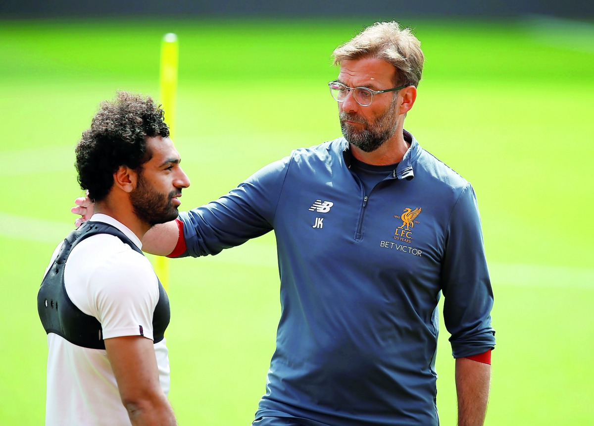 Liverpool manager Juergen Klopp (right) and Mohamed Salah during a training session at the  Liverpool Training in Anfield, Liverpool, Britain, yesterday.