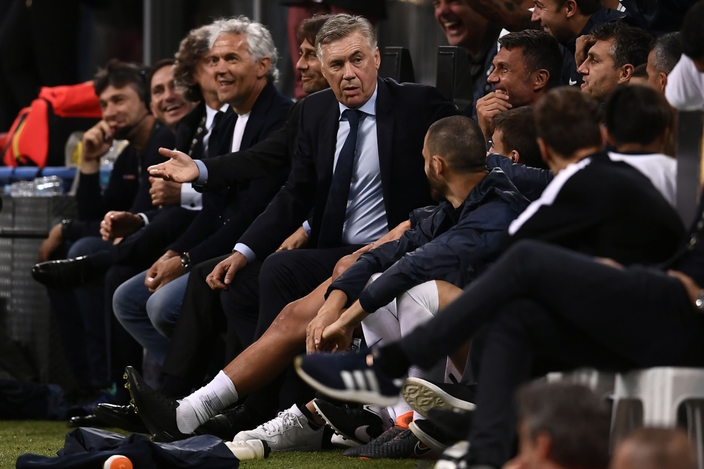 Carlo Ancelotti (C) looks on during the 