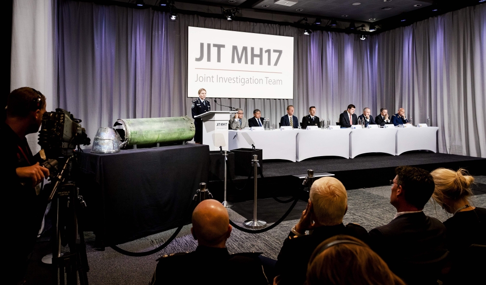 A part of the BUK-TELAR rocket that was fired on the MH17 flight is displayed on a table during the persconference of the Joint Investigation Team (JIT), in Bunnik on May 24, 2018.  AFP / Robin van Lonkhuijsen
