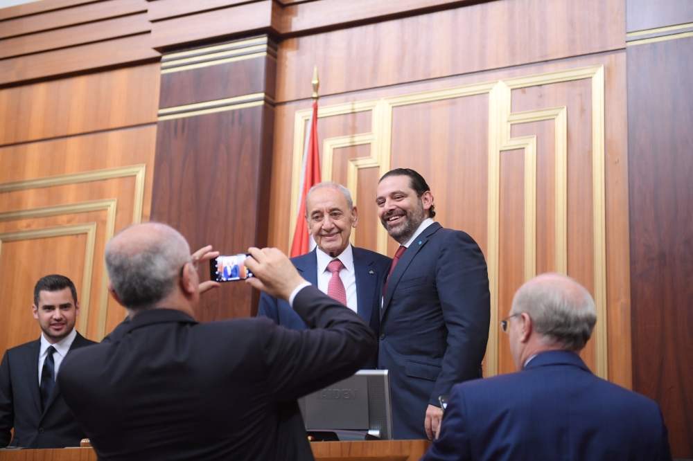 Lebanon's Finance Minister Ali Hassan Khalil takes photos of the parliamentary re-elected speaker Nabih Berri with outgoing Prime Minister Saad al-Hariri at the parliament in Beirut, Lebanon May 23, 2018. Lebanese Parliament
