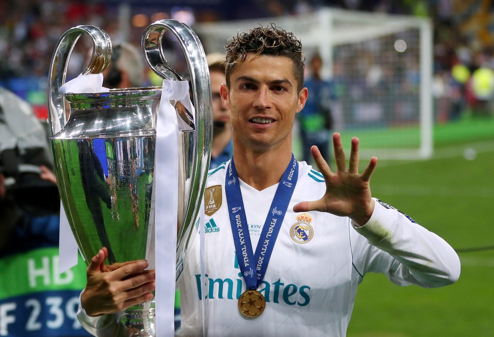 Real Madrid's Cristiano Ronaldo gestures as he celebrates winning the Champions League with the trophy REUTERS/Hannah McKay