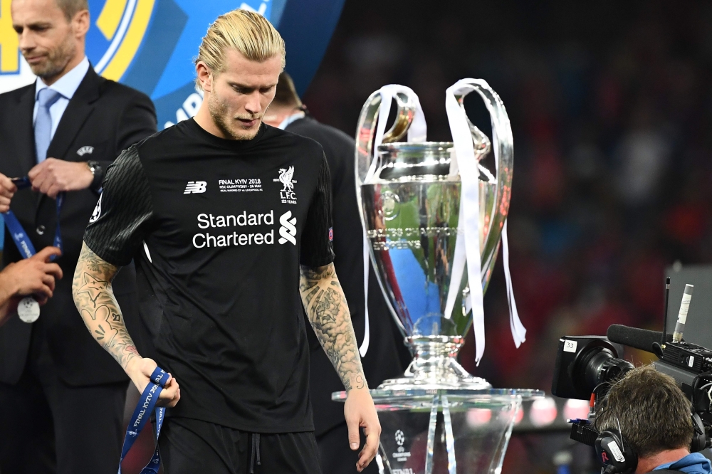 Liverpool's German goalkeeper Loris Karius walks past the trophy after losing the UEFA Champions League final football match between Liverpool and Real Madrid at the Olympic Stadium in Kiev, Ukraine, on May 26, 2018. / AFP / FRANCK FIFE